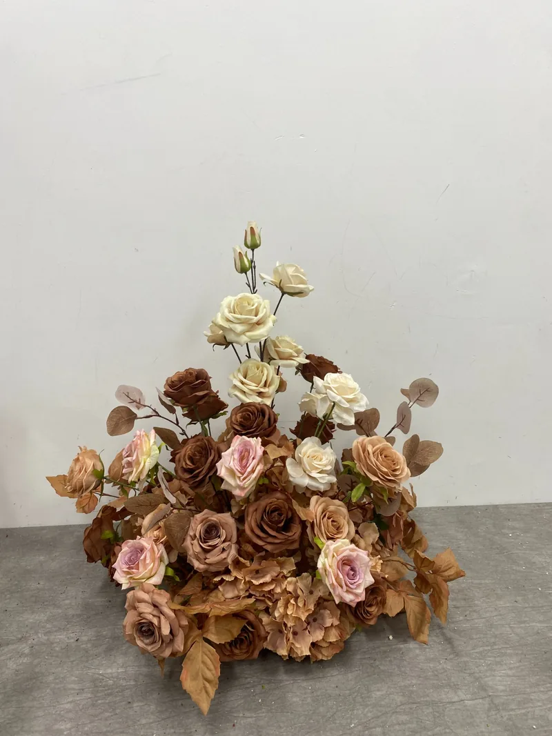 Centrepiece of champagne, rust and dusky pink roses