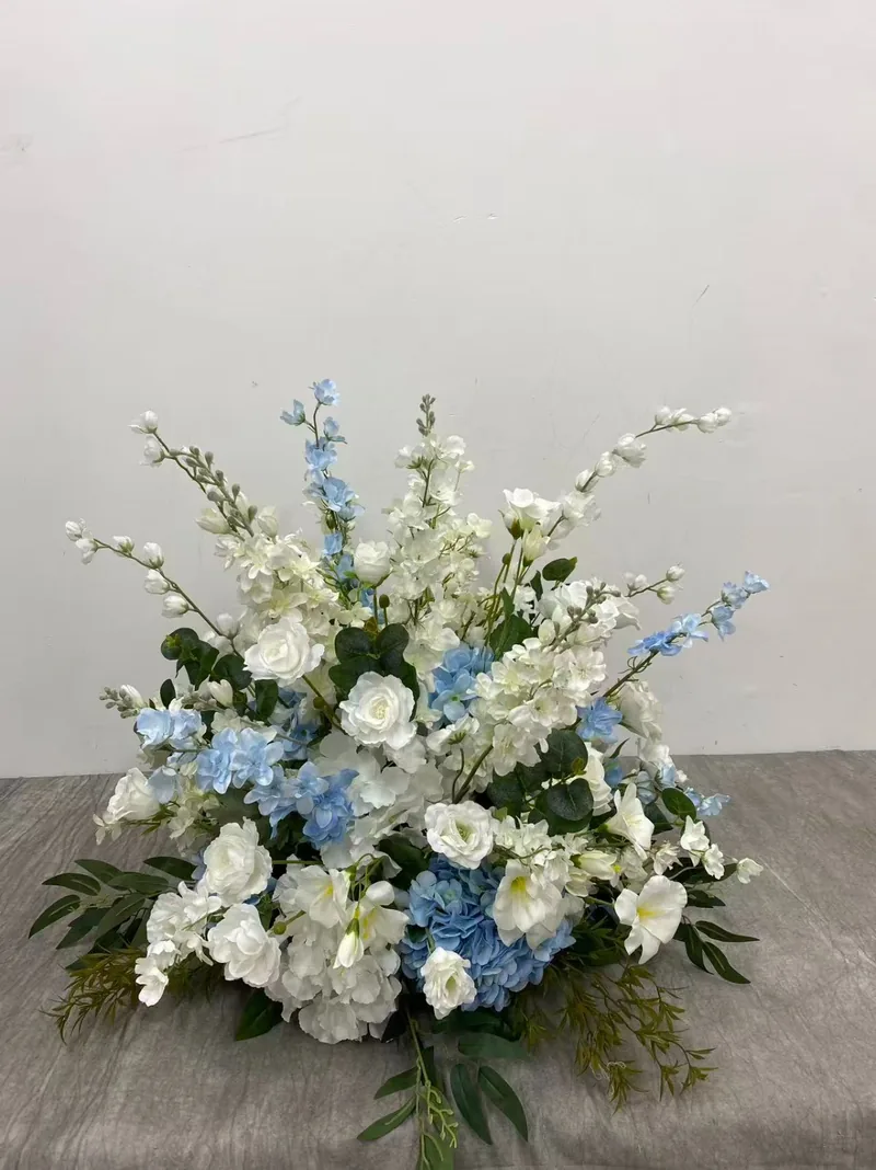Large centrepiece of ivory flowers and pale blue hydrangeas and delphiniums