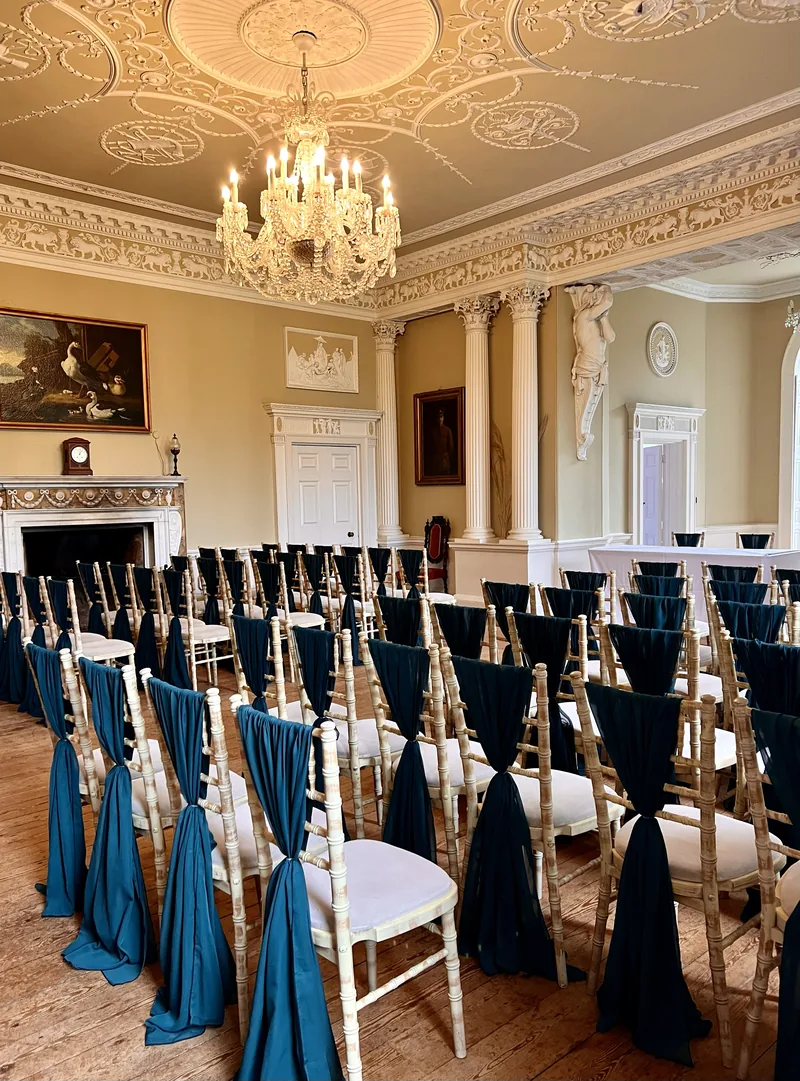 Ceremony room at Kimberley Hall with dark green chiffon chair drapes