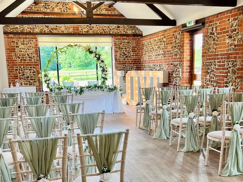 White LOVE letters beside a moon gate and ceremony table in the Park Room at Hunters Hall