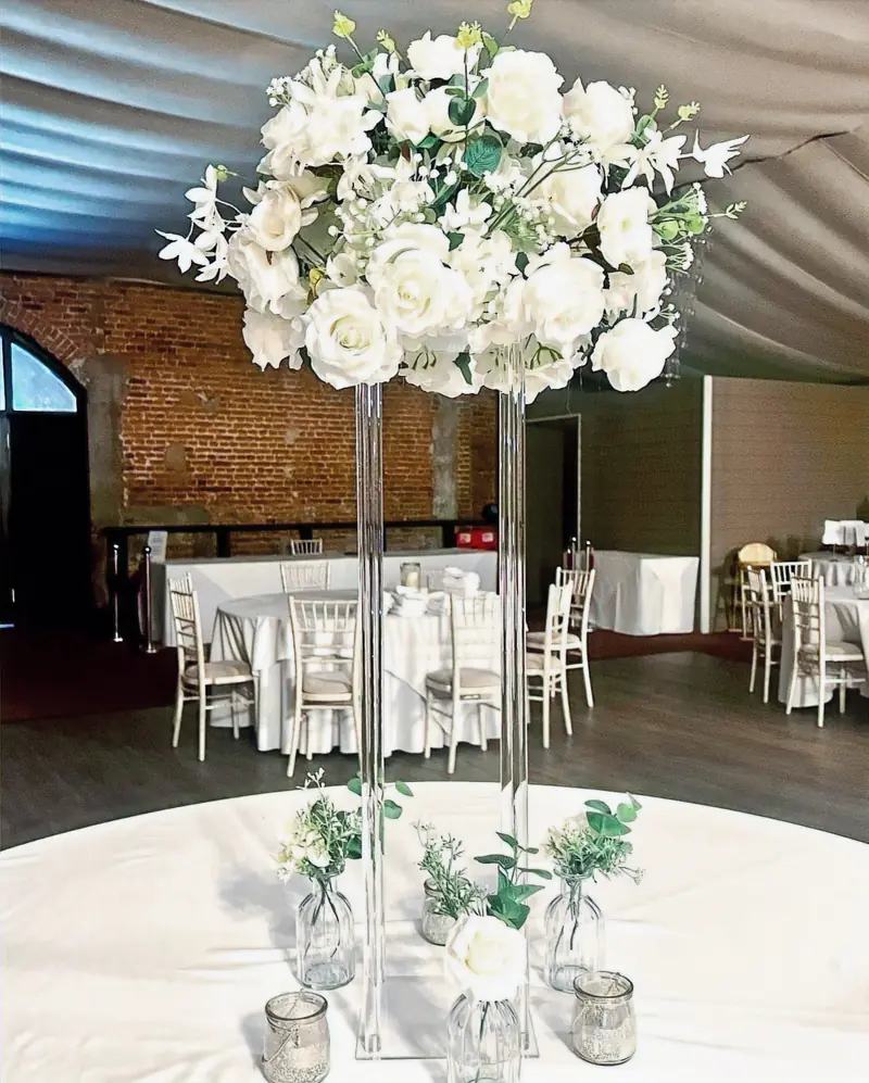Large ivory centrepiece on a tall acrylic stand