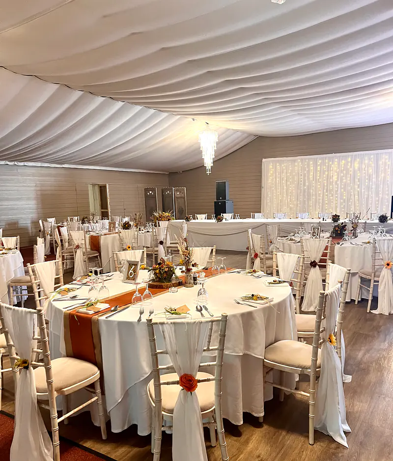 Starlit backdrop behind the top table at a wedding breakfast styled in ivory and rust