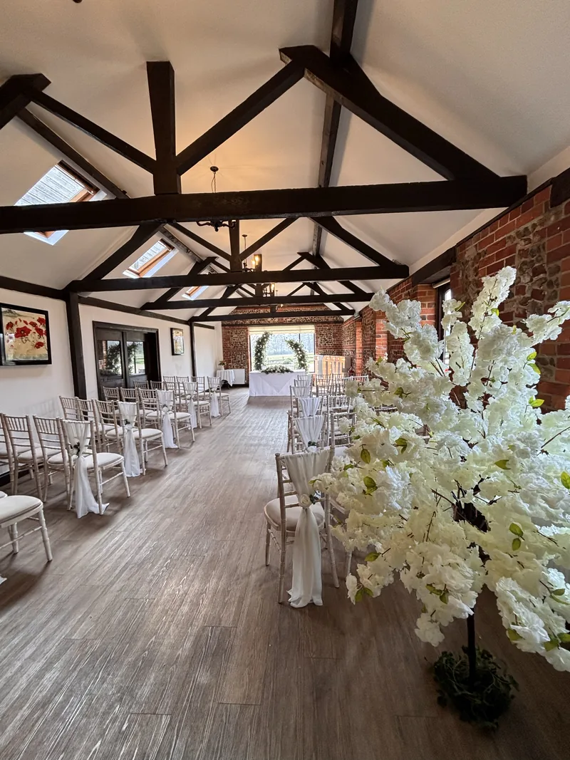 Ivory blossom tree beside the aisle in the Park Room at Hunters Hall